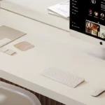 Caesarstone ICON 4001 Fresh Concrete in Modern workspace with iMac, wireless keyboard, mouse, chair, and neatly arranged stationery.