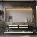 Caesarstone Quartz 4044_Airy Concrete surface in Modern bathroom with double sinks, large illuminated mirror, hanging plants, and walk-in shower.