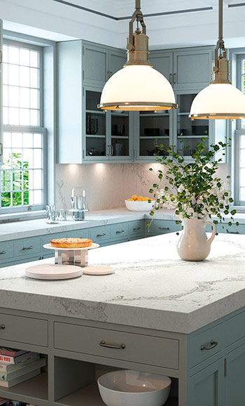Caesarstone ICON 5131 Calacatta Nuvo surface in Modern kitchen with wooden cabinets, marble island, bar stools, built-in ovens, and a large plant.