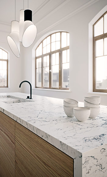Caesarstone ICON 5143 White Attica in Modern kitchen with olive green cabinets, marble countertops, island, bar stools, and pendant lights.