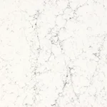 Caesarstone ICON 5143 White Attica White marble surface with subtle gray veining, smooth and polished texture.