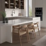 Caesarstone Quartz 6141 Ocean Foam surface in Modern kitchen with white island, wooden chairs, built-in oven, open shelves, and large window.