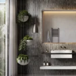 Caesarstone 4044 Airy Concrete surface in modern bathroom with hanging plants, textured dark wall, floating sink, and large illuminated mirror.