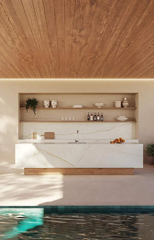 Caesarstone Porcelain 508 Isobellia in modern outdoor kitchen and dining area beside a pool, featuring sleek white countertops.